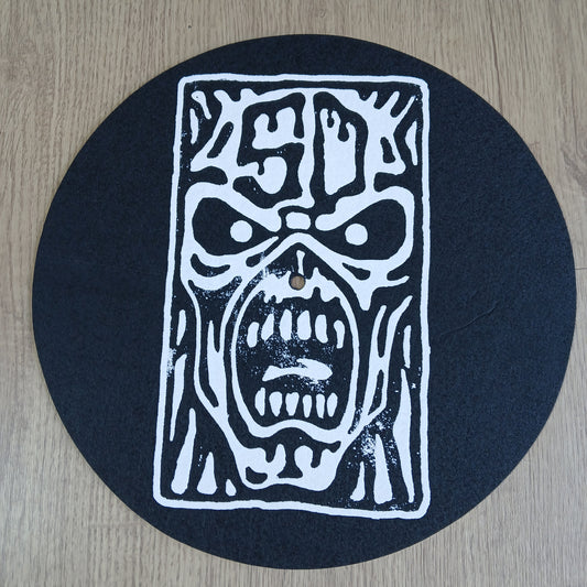 Black circular mat with white abstract design on a wooden surface