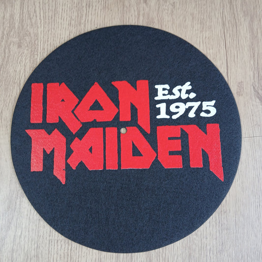 Round mat with Iron Maiden est. 175 logo and text on a wooden floor