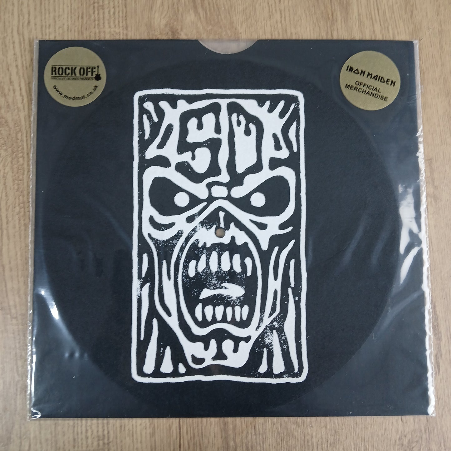 Package shot of Iron Maiden official slipmat featuring a weoodcut effect of Eddies face.