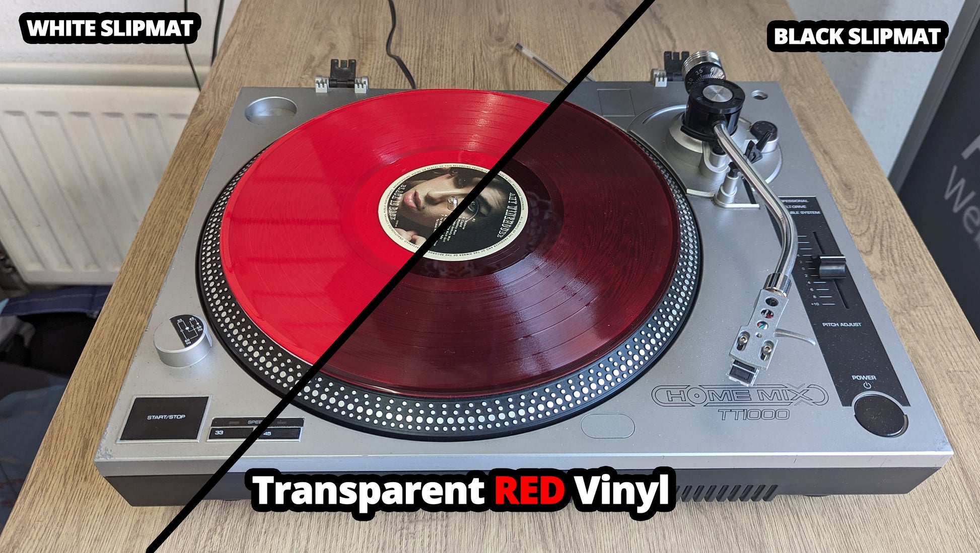 Turntable with transparent red vinyl on a wooden surface, labeled for white and black slipmat options.
